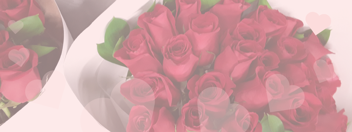 Bouquet of red roses with green leaves in a white box.