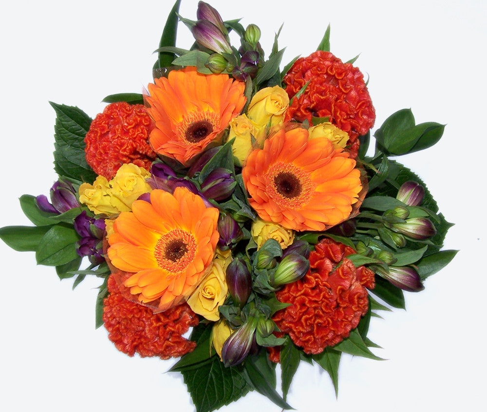 Seasonal red, yellow, orange and purple blooms with greenery