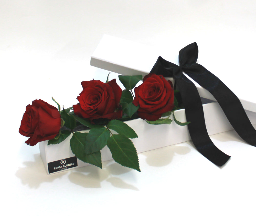 3 red roses in a long gift box