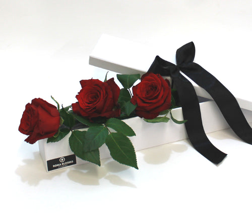 3 red roses in a long gift box