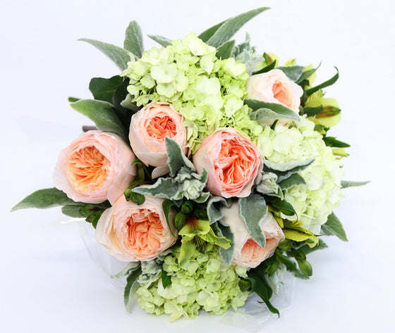 Peach roses.  - Lush foliage of green and whites.