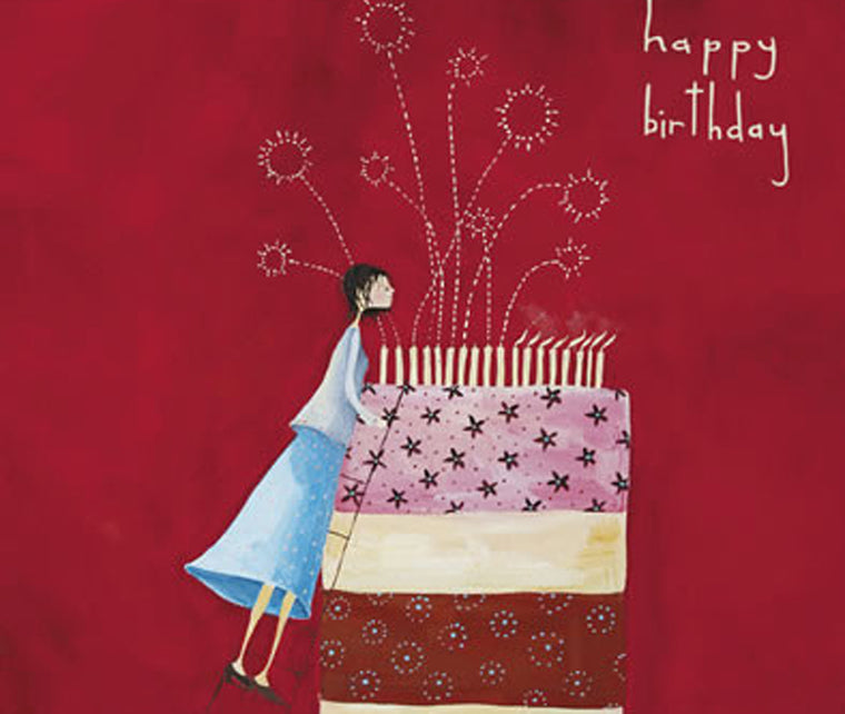 A girl blowing candles out on a cake